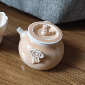 ceramic teapot with a cute flower illustration